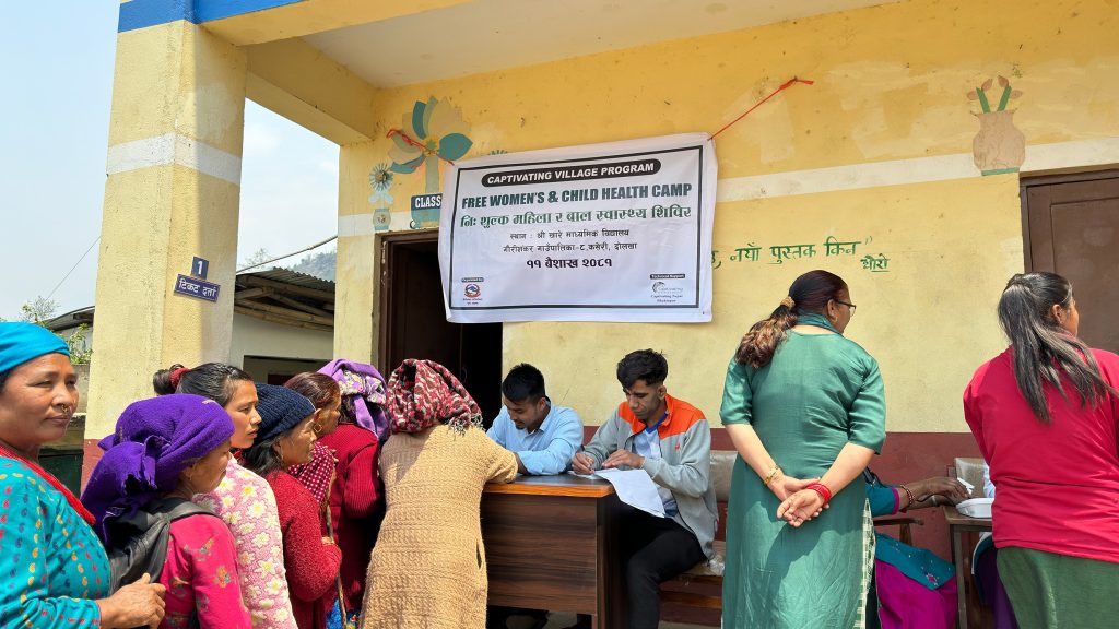 women waiting in line to register for a free health camp