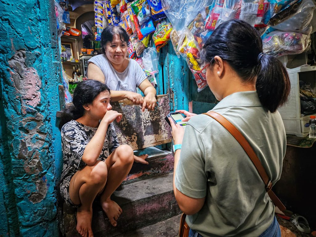 One staff member interviewing Aryana and her grandmother by their store