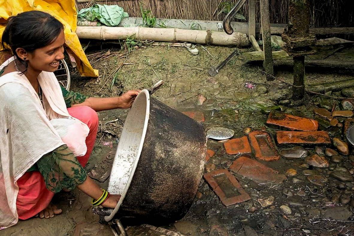 Teenage girl from Nepal washing a basin