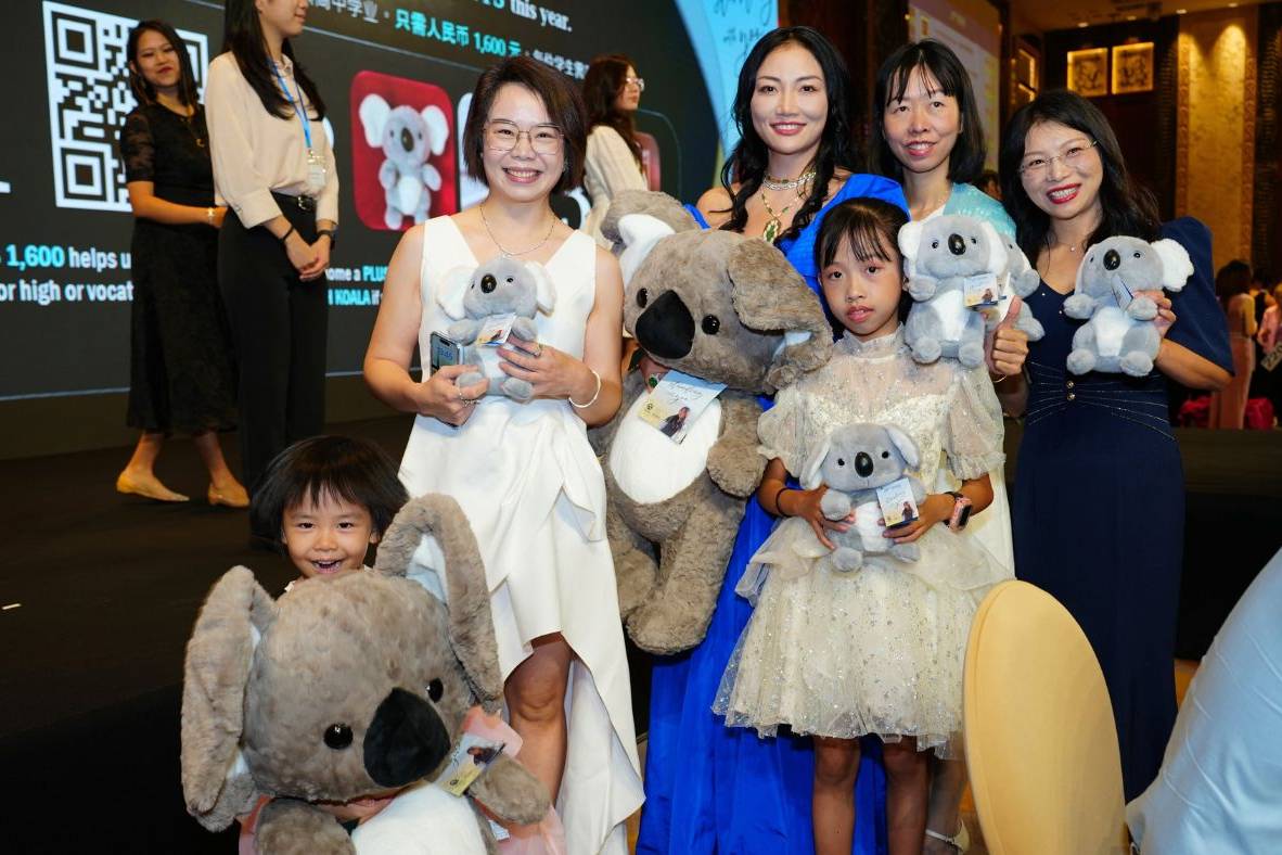 Attendees holding koala plushies