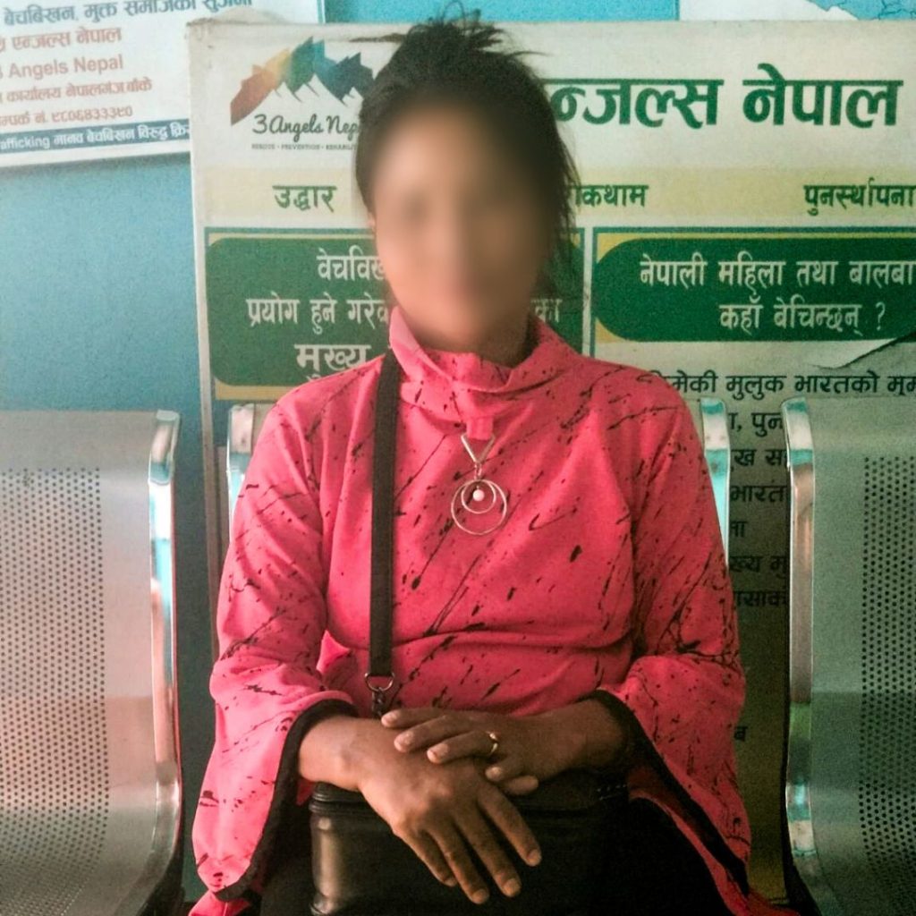 Woman sitting on a chair with faced blurred for privacy