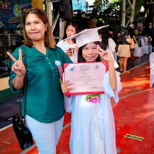 Mother and daughter at the daughter's elementary school graduation ceremony