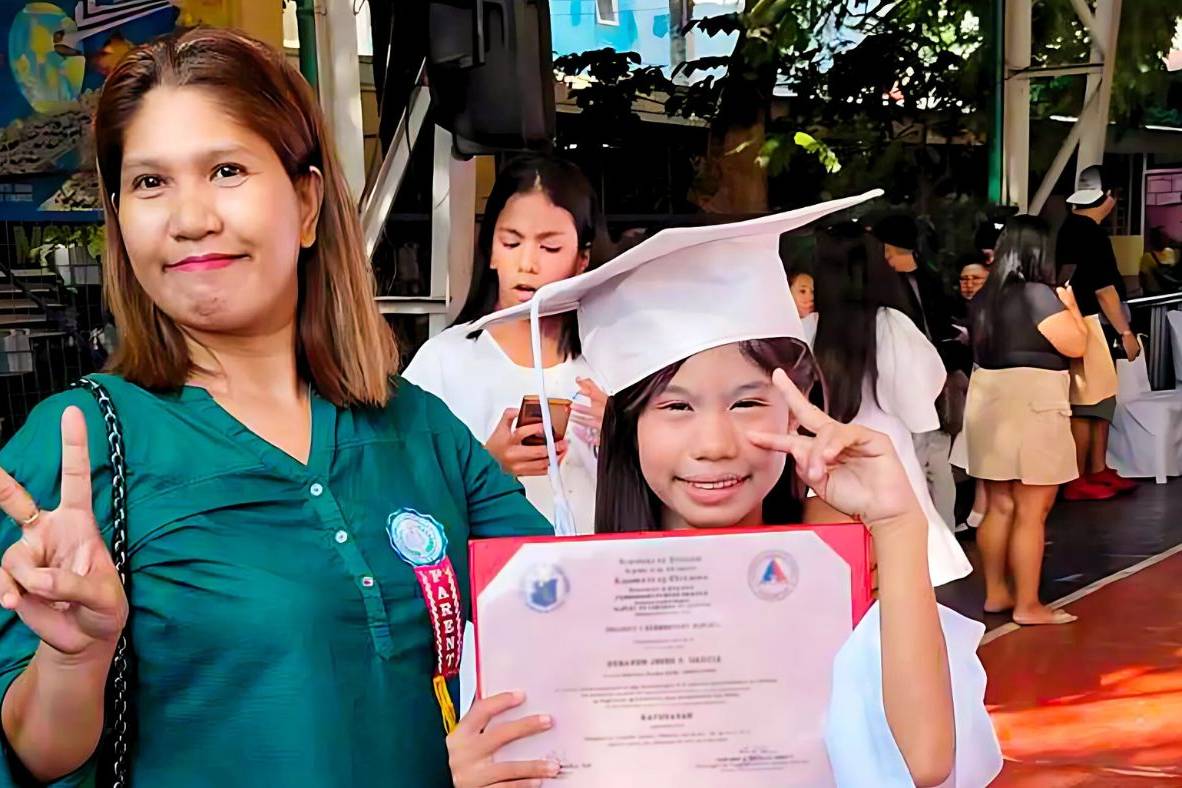 Mother and daughter at the daughter's elementary school graduation ceremony