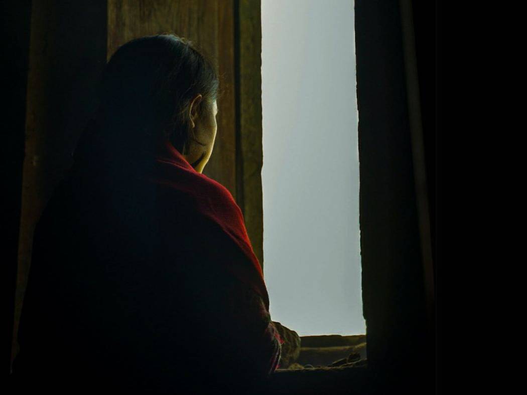 Woman looking out a window