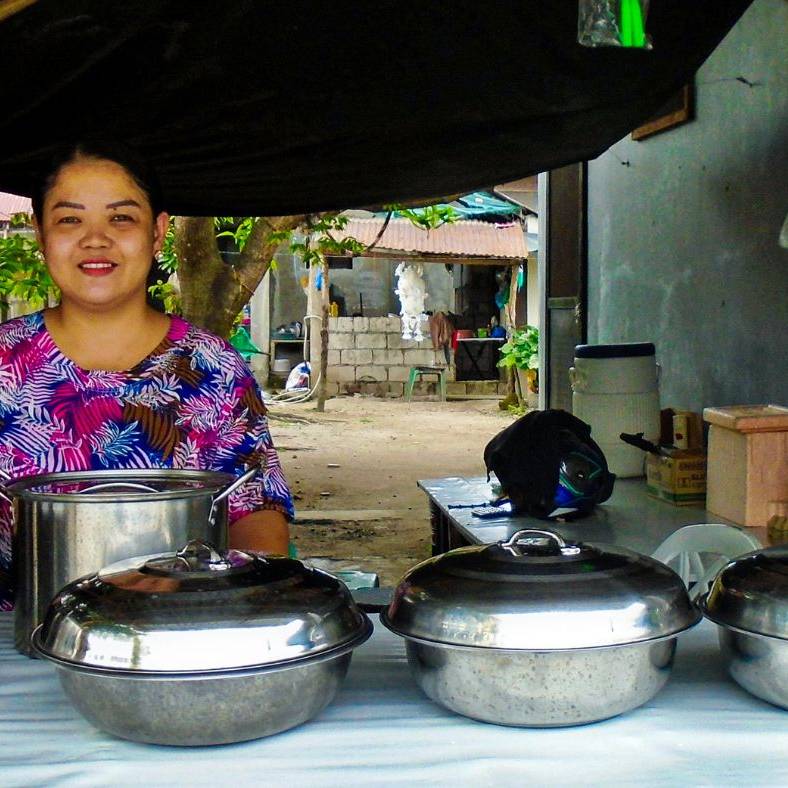 Filipino woman manning a food stand