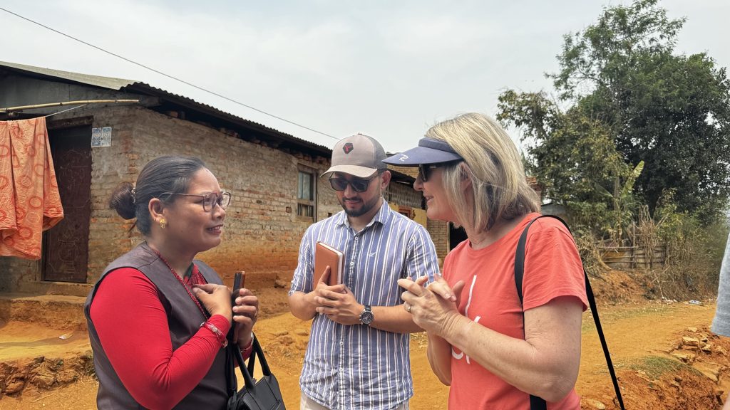 Photo of Australian woman and man interviewing a Nepali woman