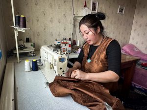 Chinese woman sewing on a machine