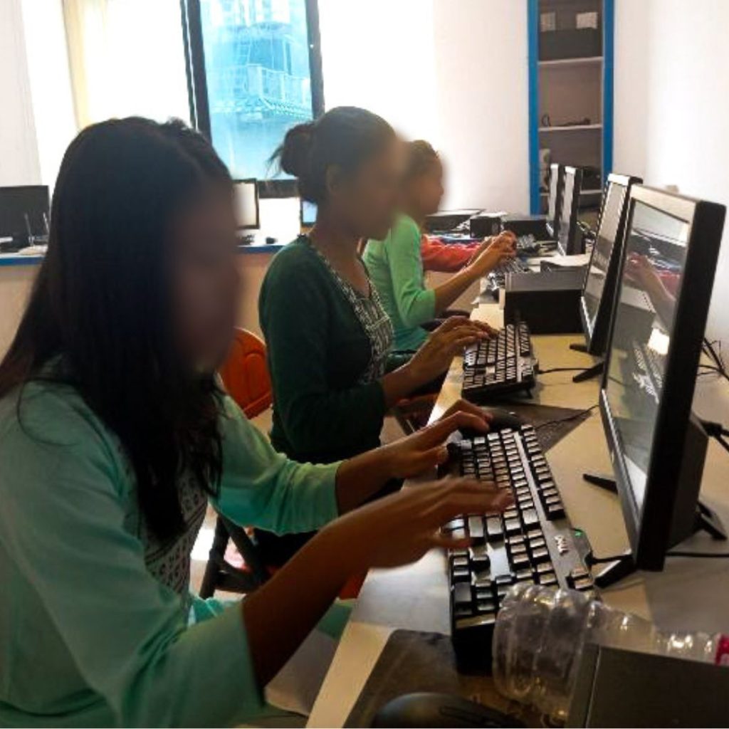 Three Nepali women training on how to use computers