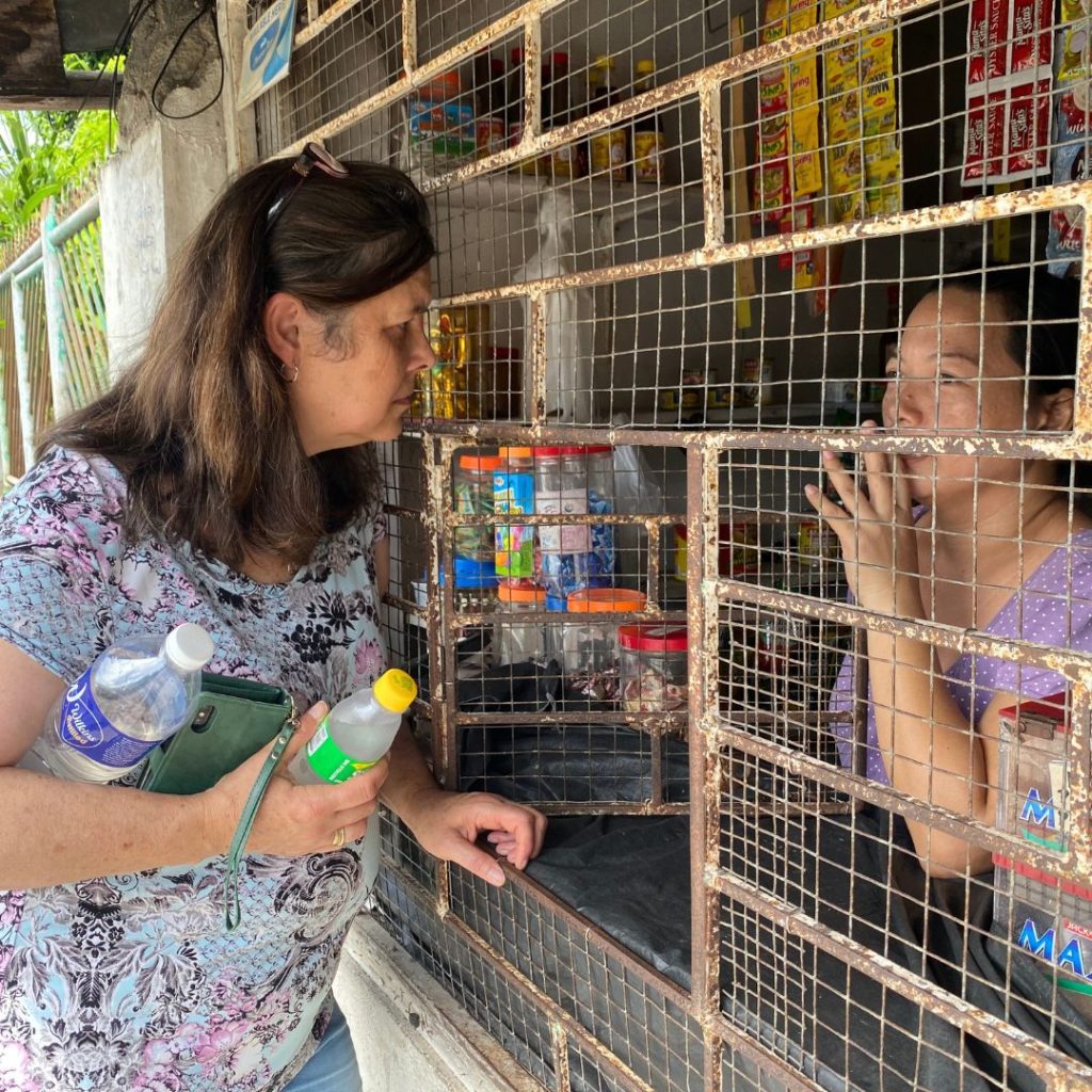 Australian staff member talking to a woman in her shop