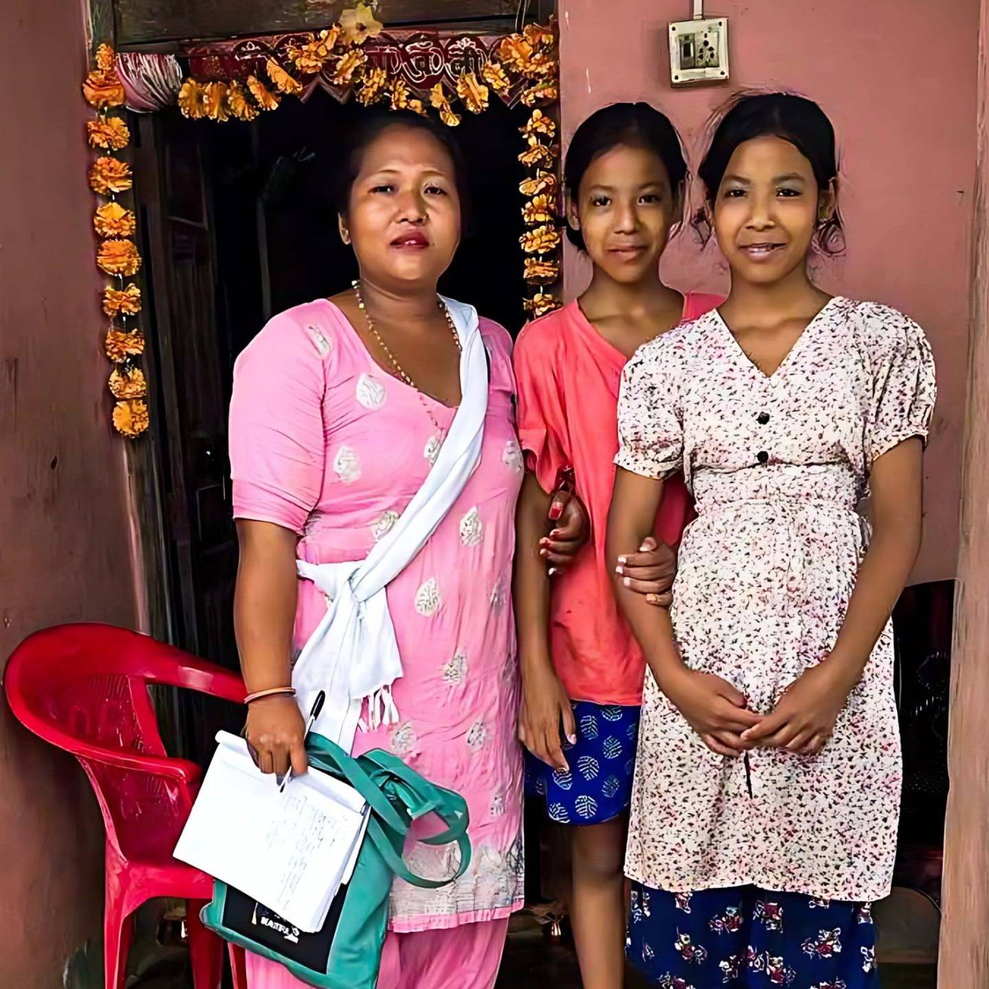 Woman posing with teenage twin girls