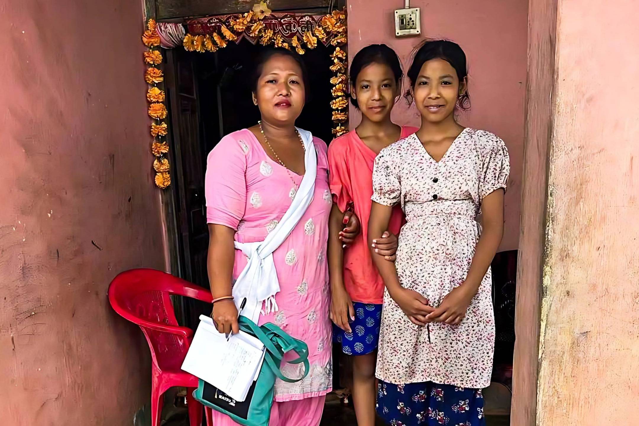 Woman posing with teenage twin girls