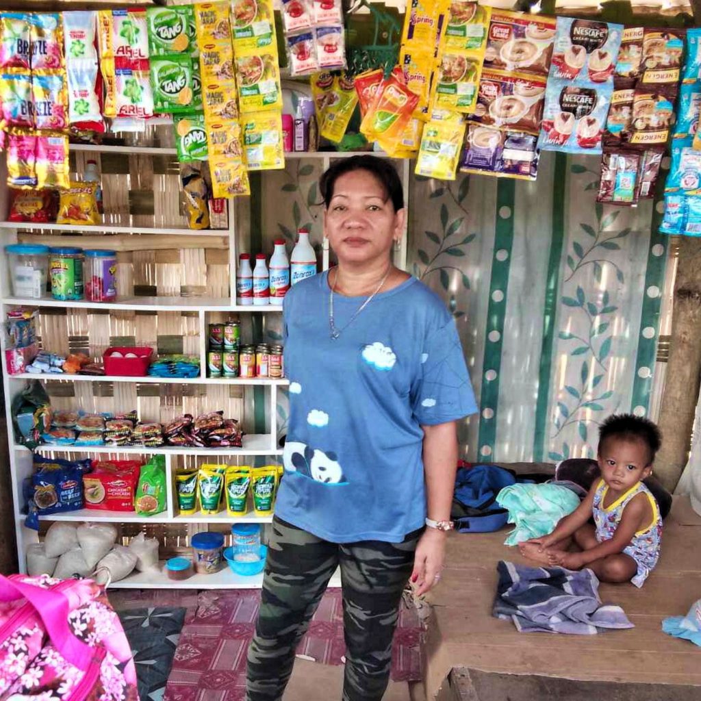 Filipino woman and her small child in her variety store