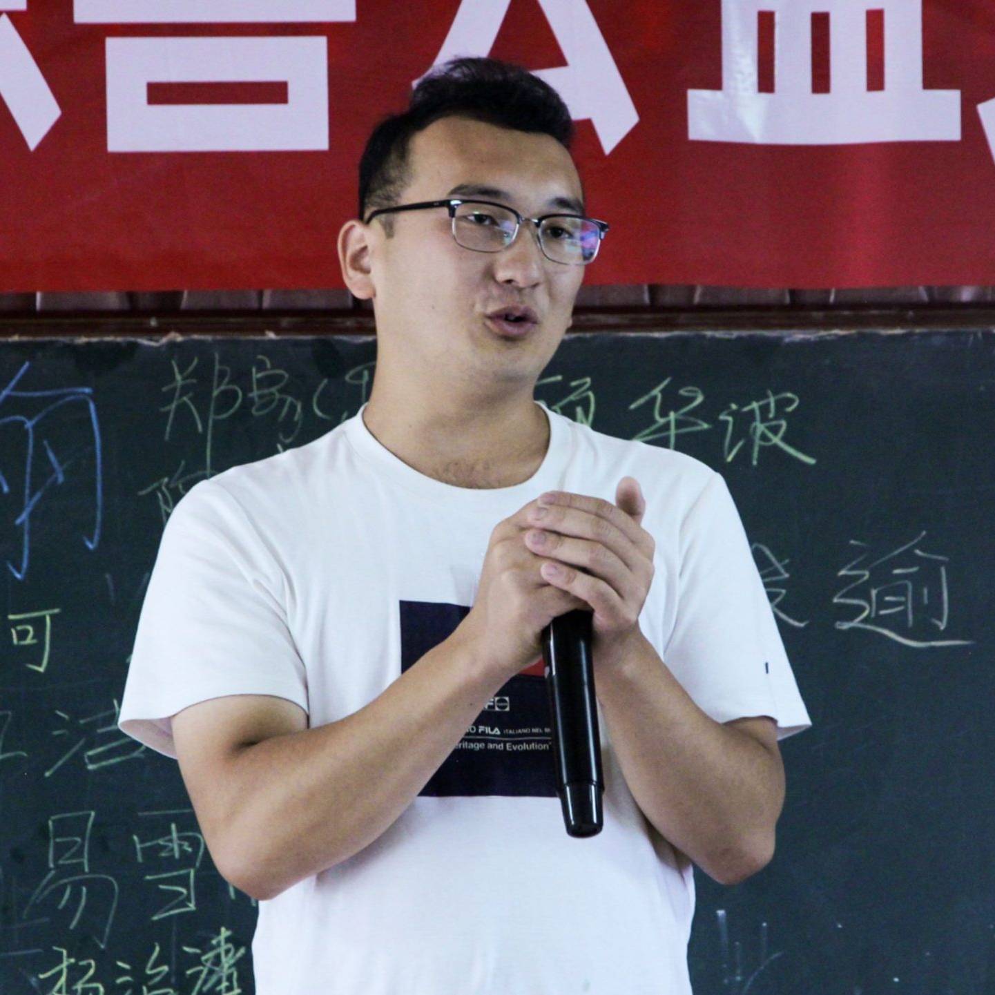 A male teacher speaking passionately in front of a classroom.