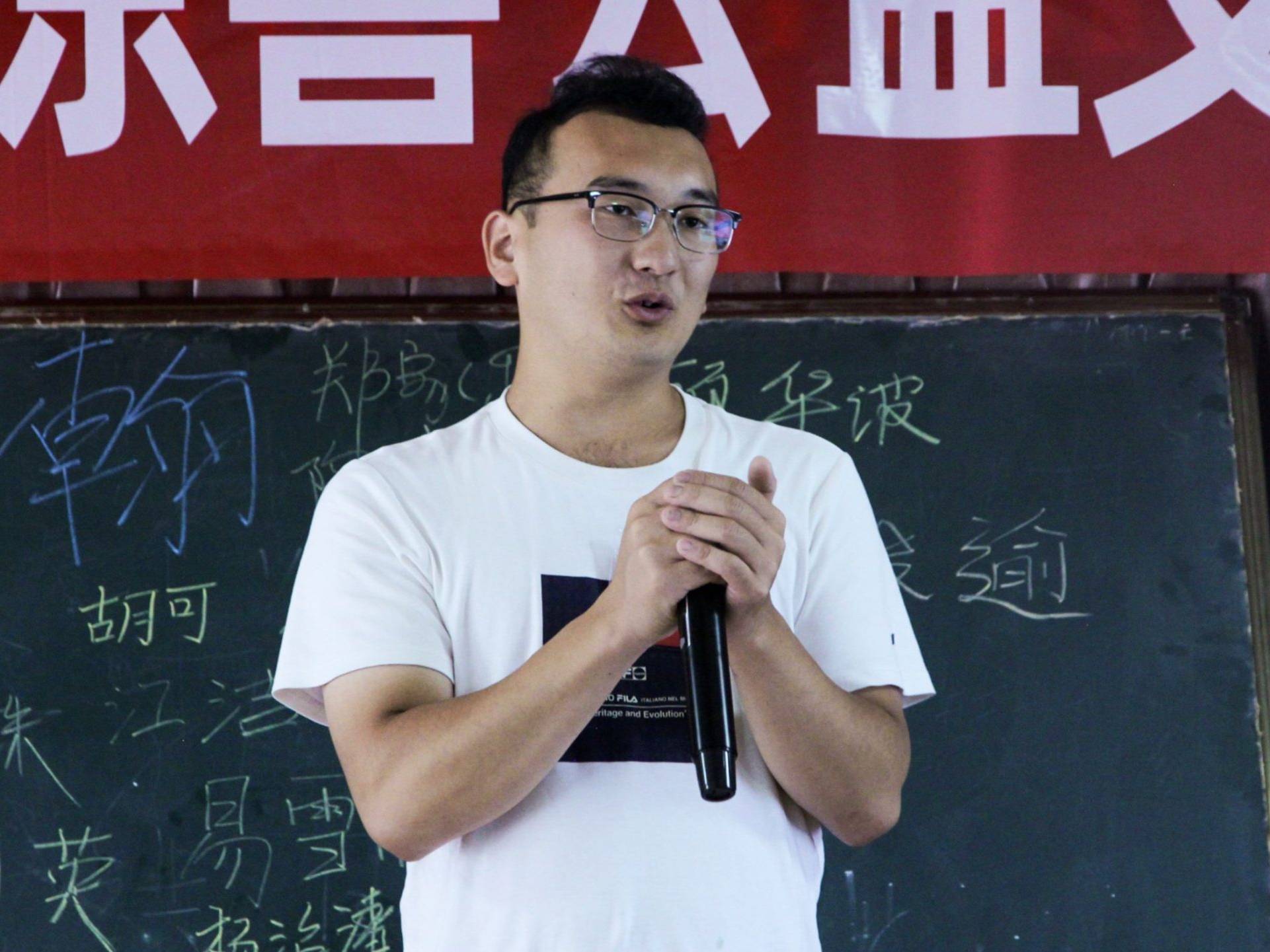 A male teacher speaking passionately in front of a classroom.