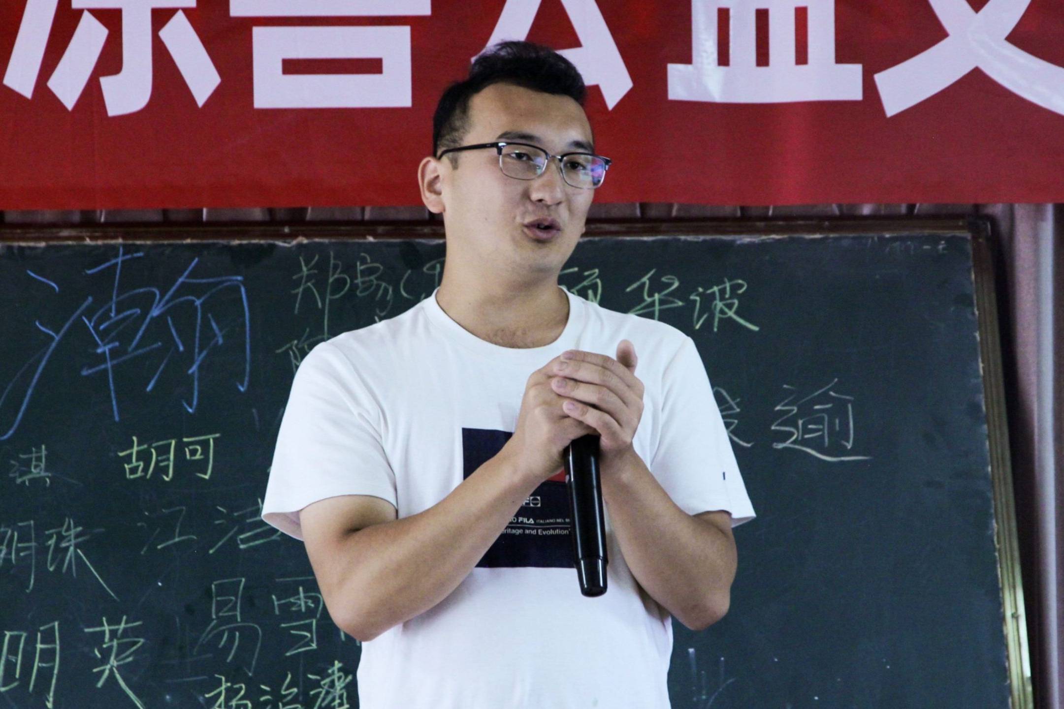 A male teacher speaking passionately in front of a classroom.