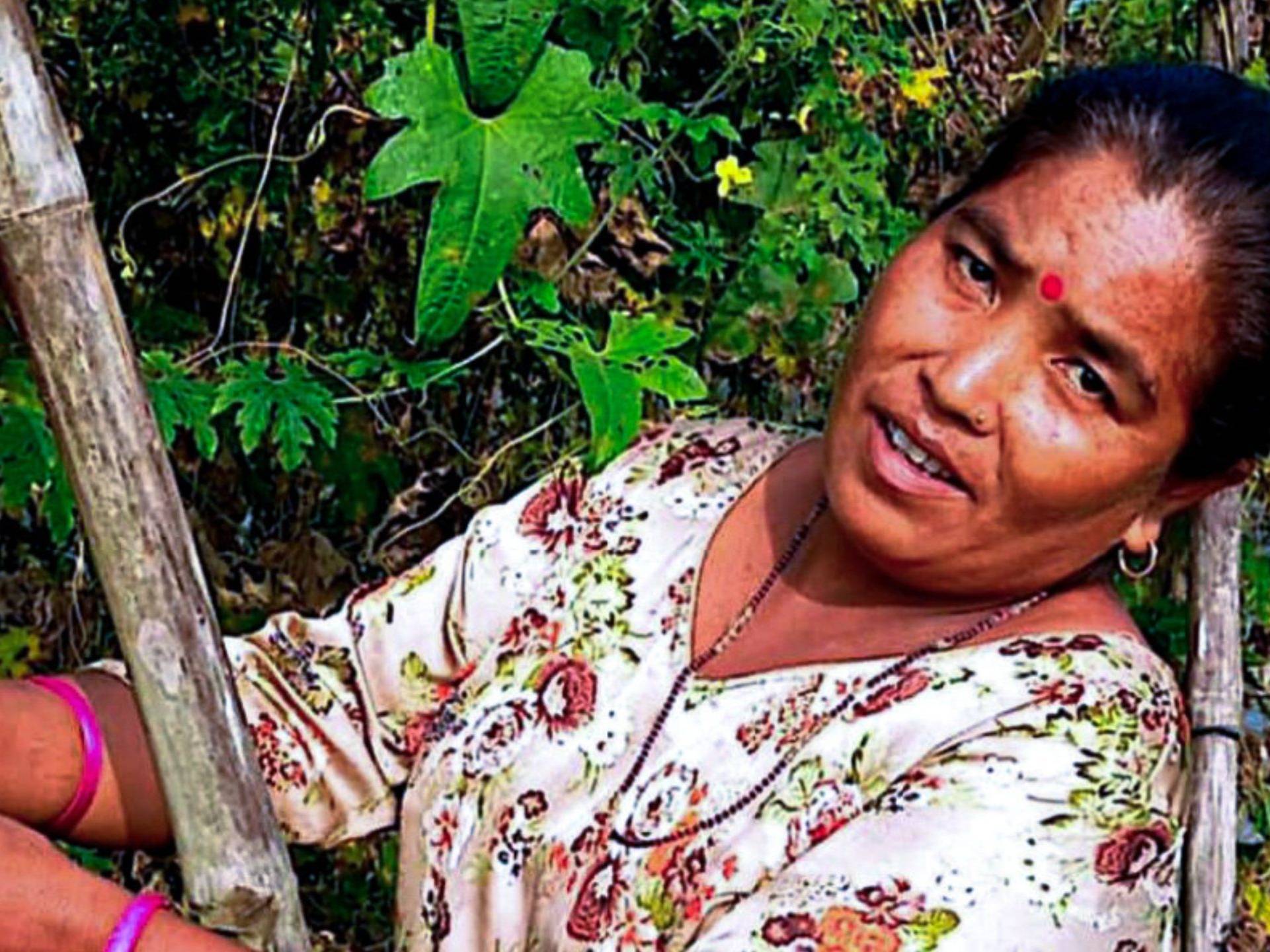 A woman harvesting fresh produce from her vegetable farm.