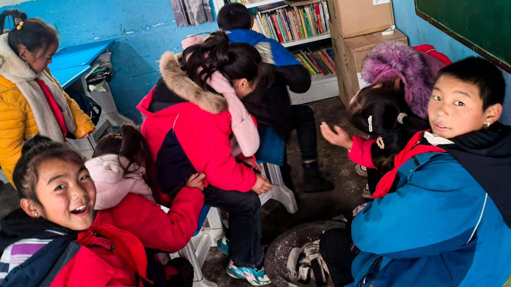 Several children seated and collaborating on activities in a classroom environment.