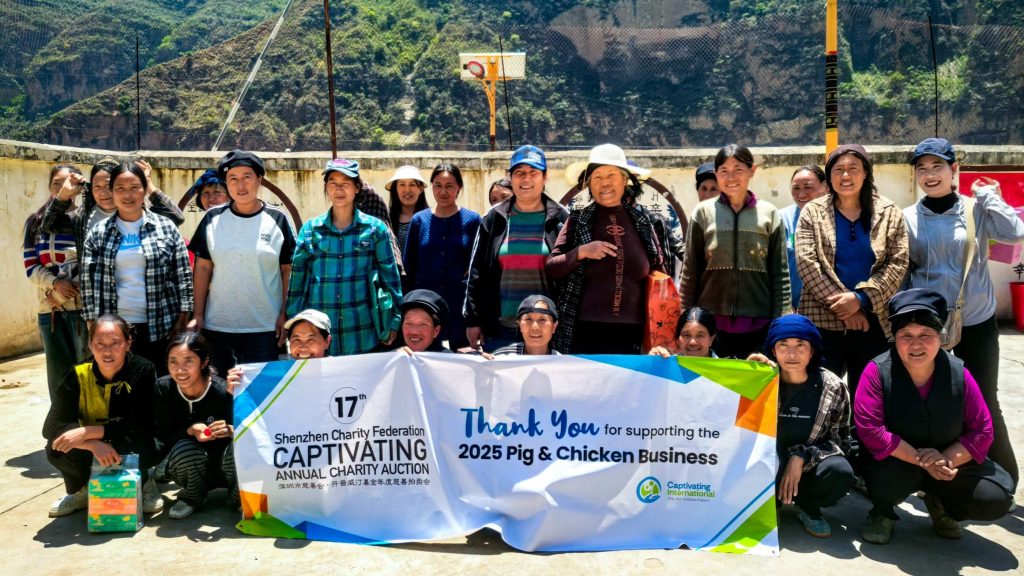 A group of diverse individuals smiling and posing together, holding a banner that displays a message.