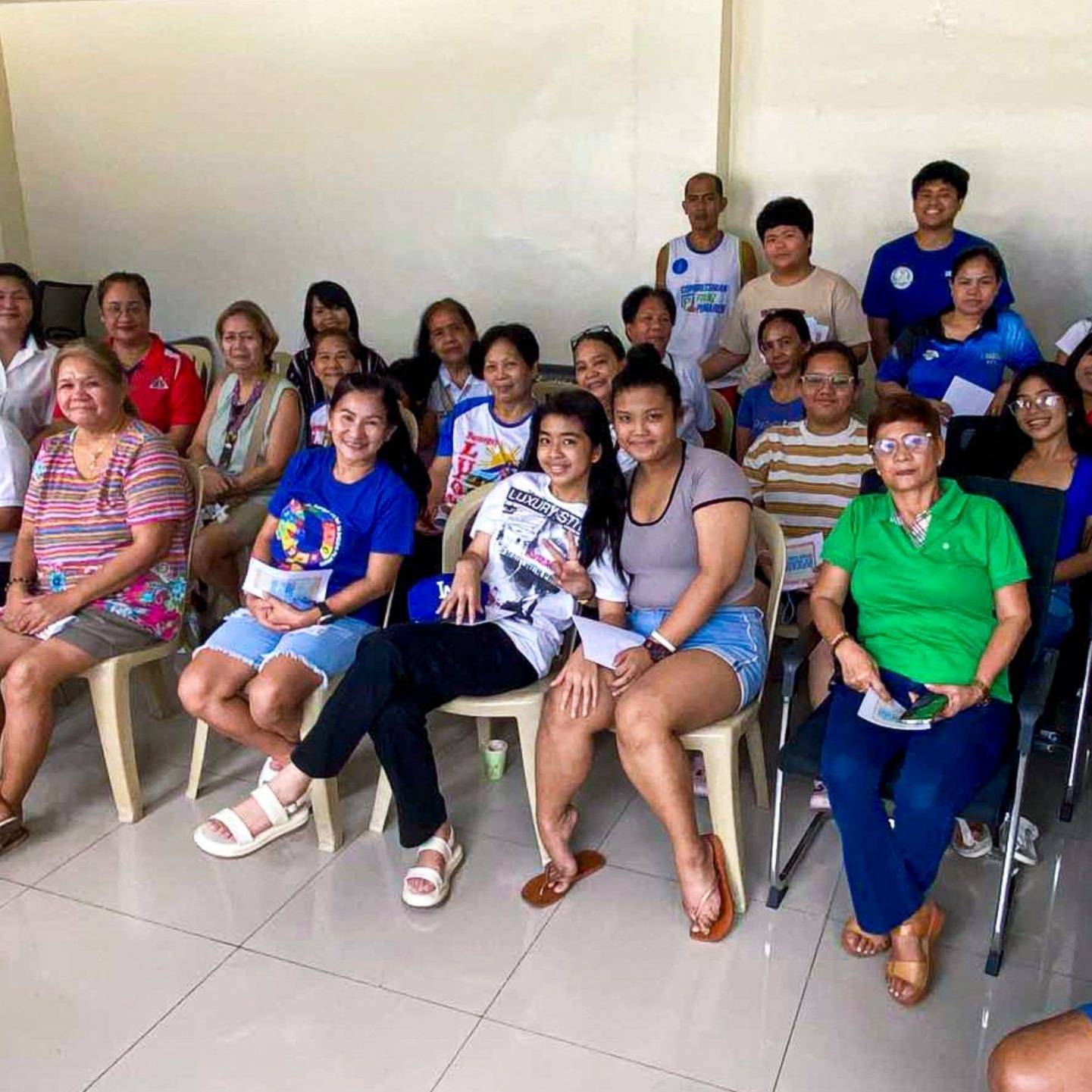 A diverse group of people sitting together in a room.