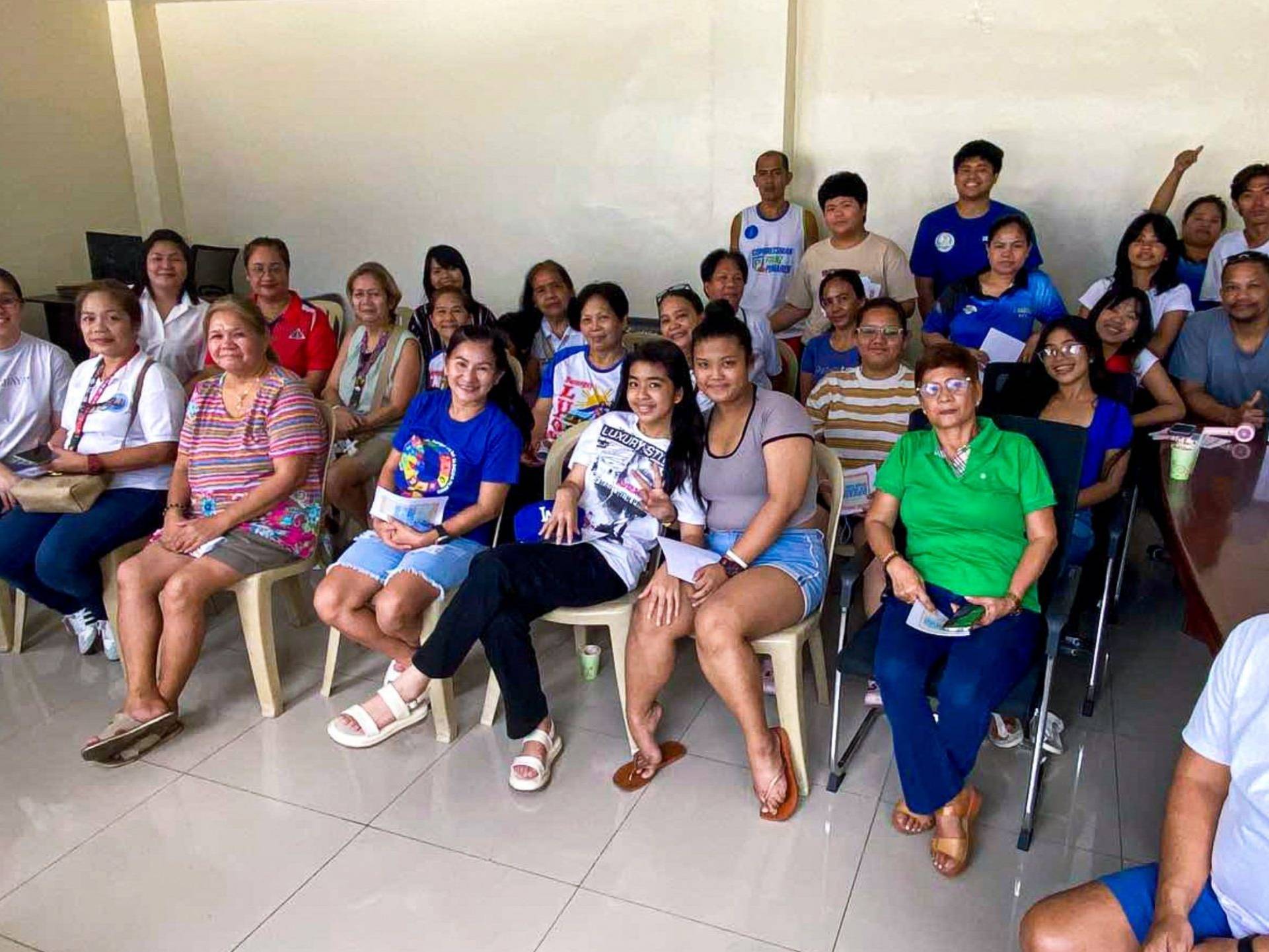 A diverse group of people sitting together in a room.