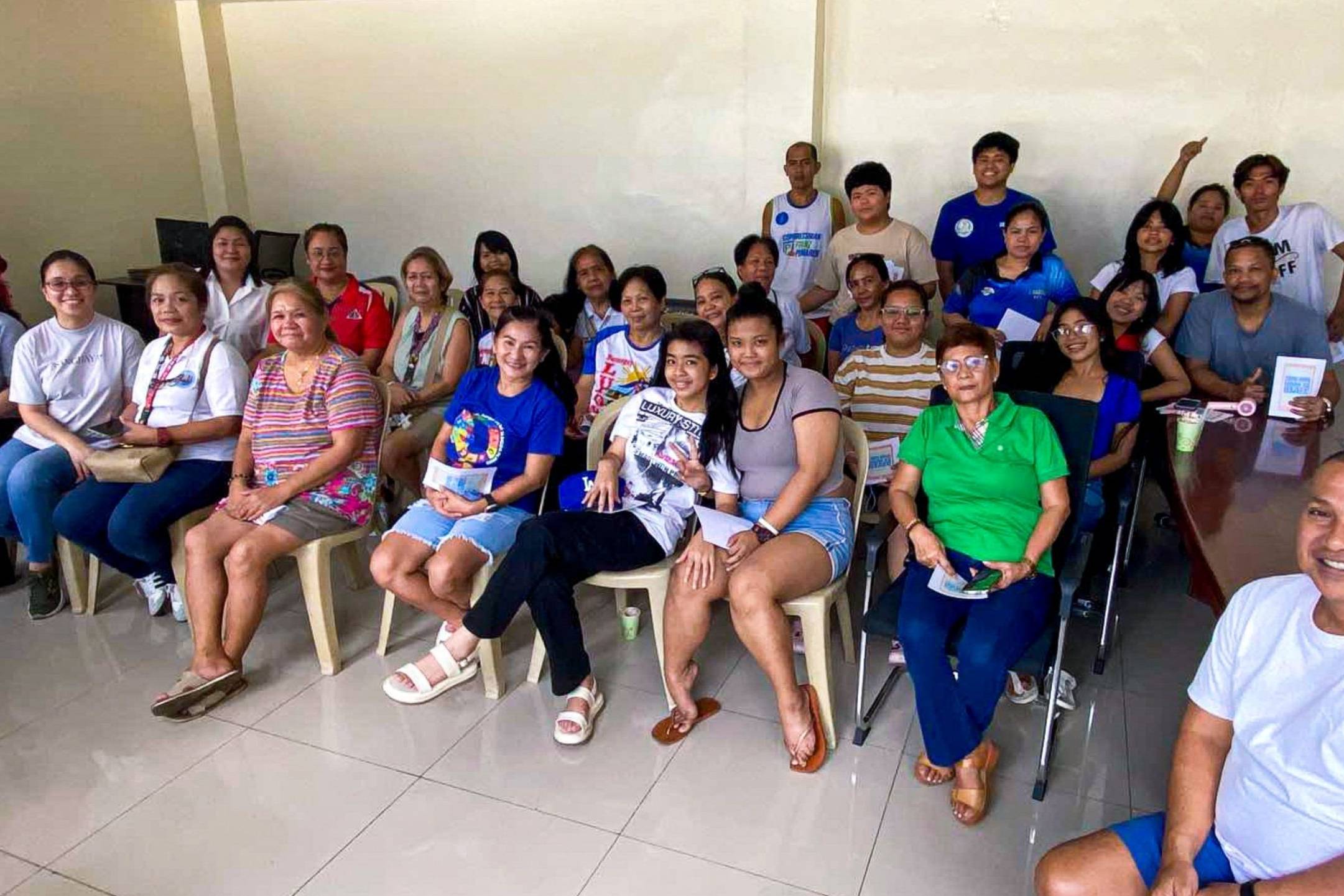A diverse group of people sitting together in a room.