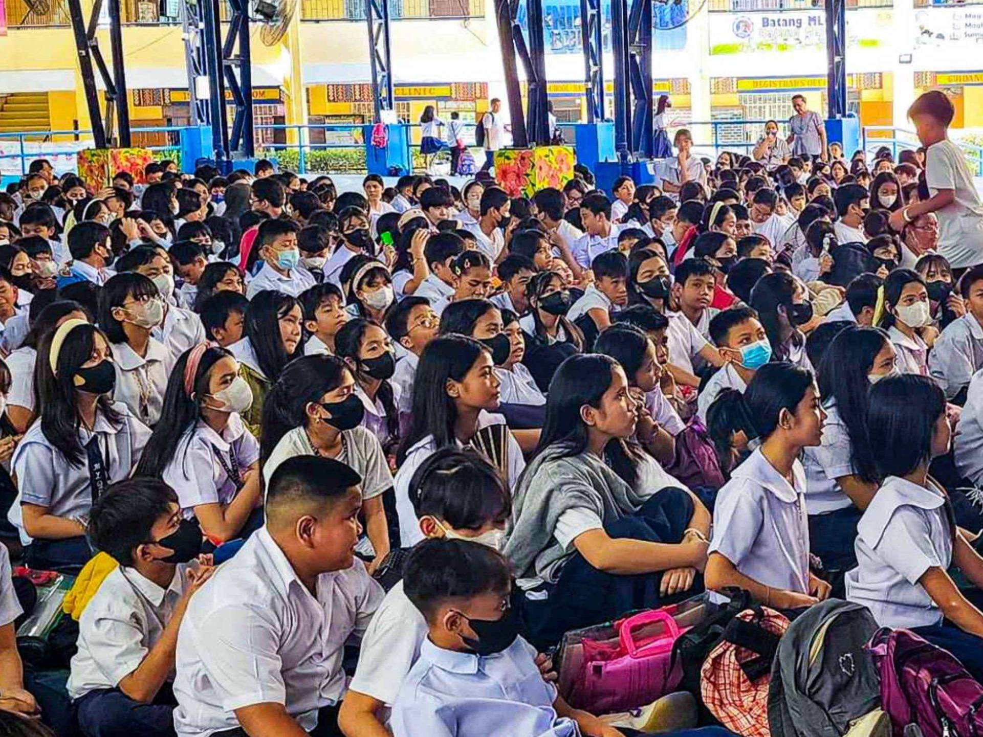 A diverse group of students sitting together in a school setting.