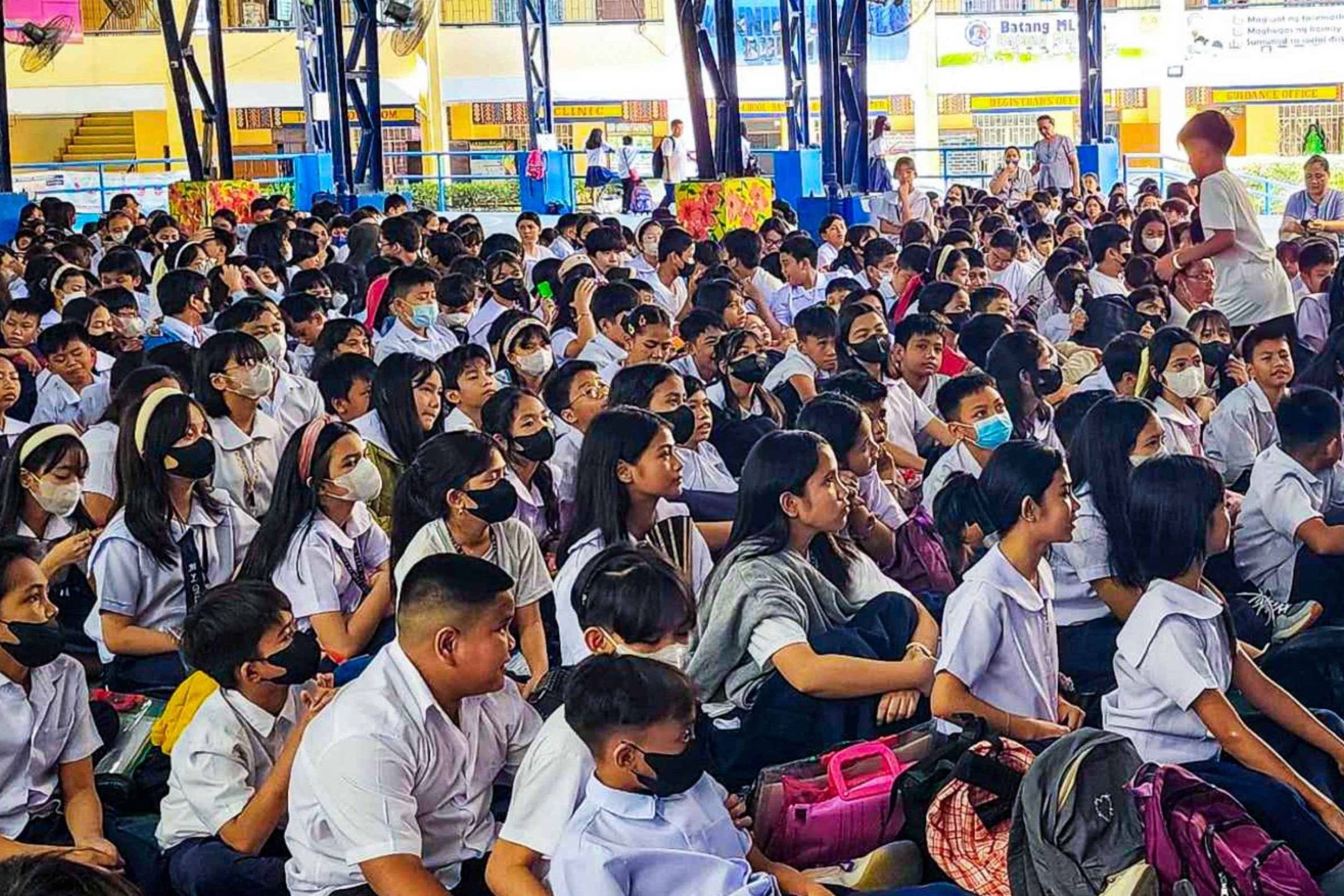 A diverse group of students sitting together in a school setting.