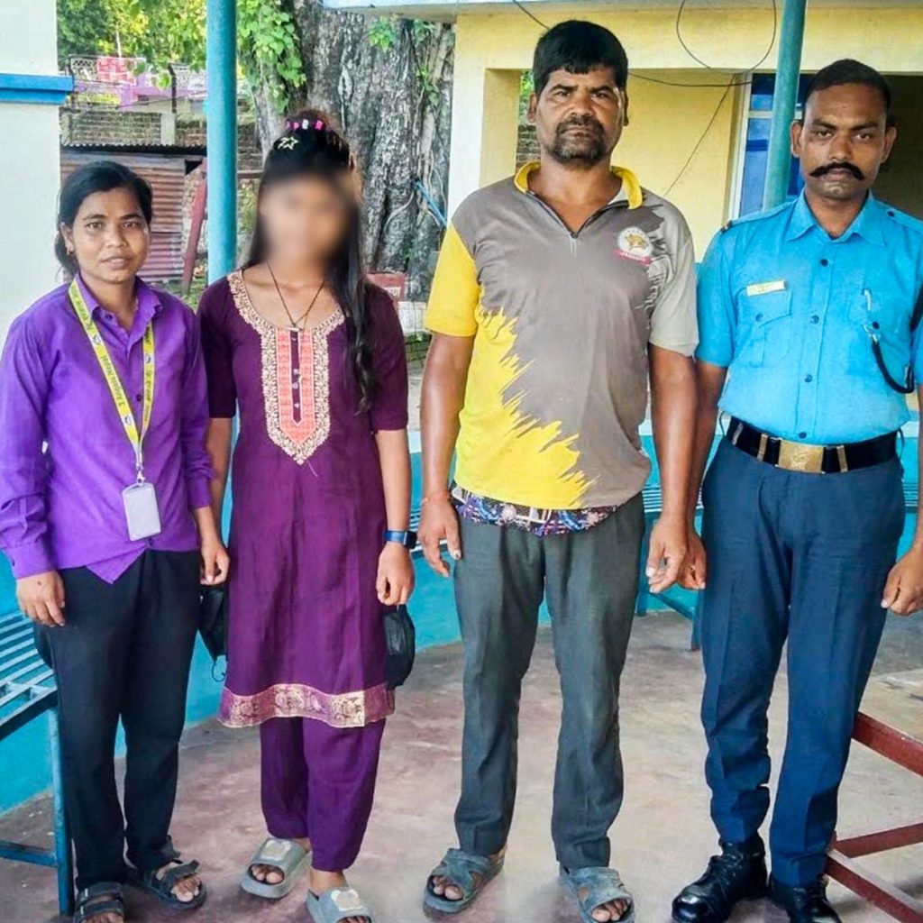 A group of four individuals poses side by side. The face of the second woman blurred for privacy.