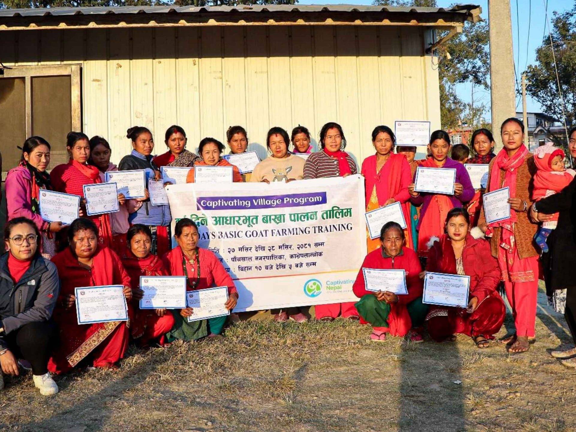 A group of people proudly displaying certificates in front of a building, celebrating their achievements together.