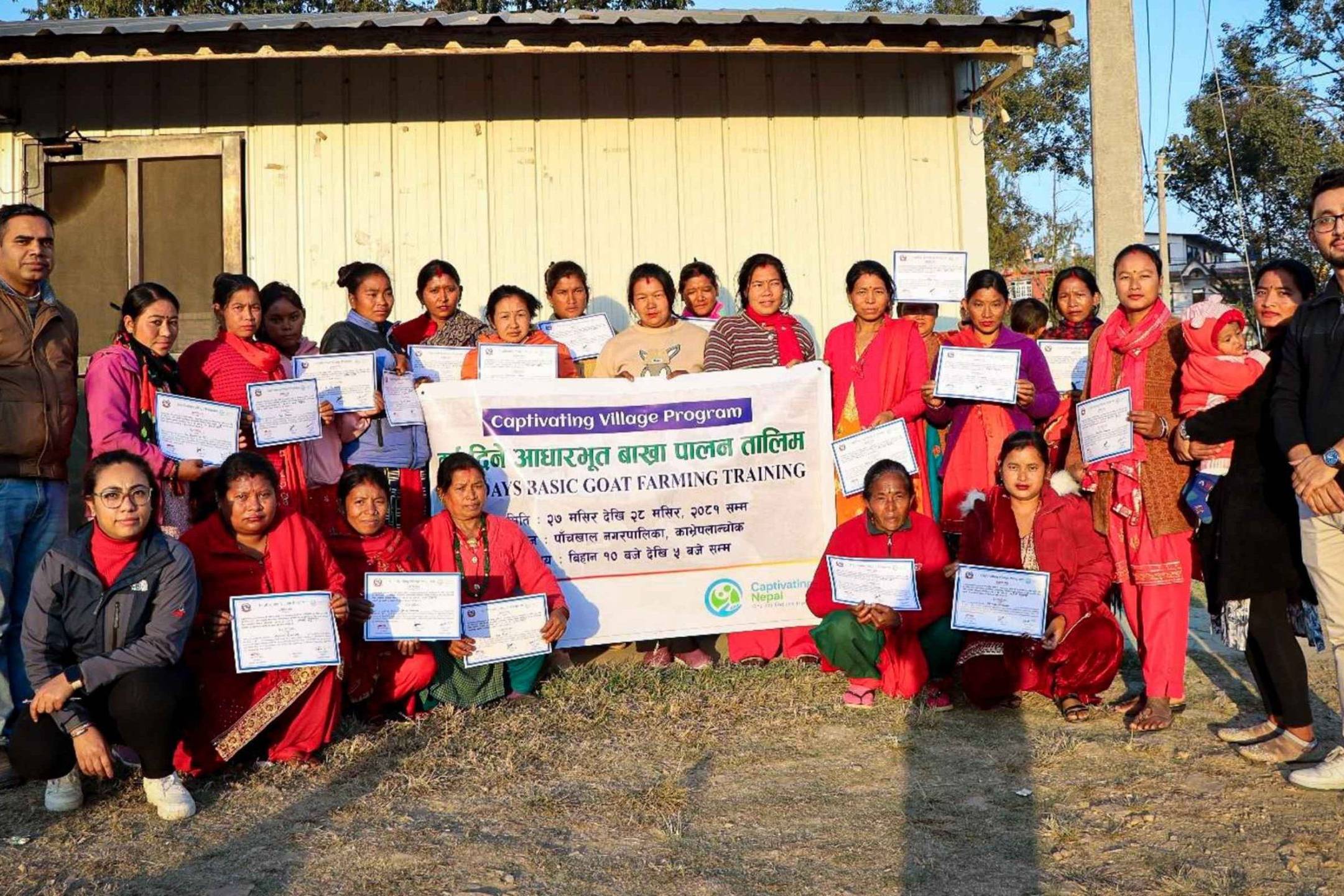 A group of people proudly displaying certificates in front of a building, celebrating their achievements together.
