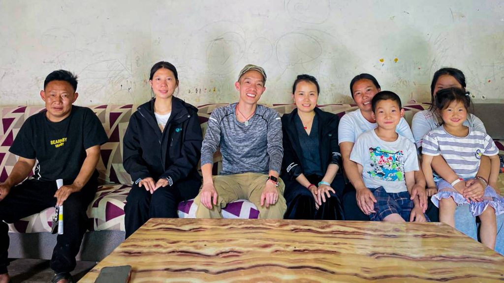 A diverse group of eight individuals relaxing on a couch, sharing laughter and enjoying each other's company.