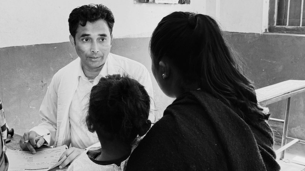 A doctor discusses health matters with a woman and her child.