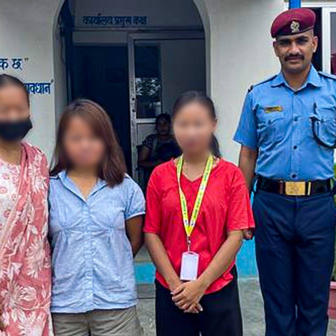 A group of three people, with faces blurred, stand beside a smiling police officer in uniform outside a building. The tone appears formal and cooperative.