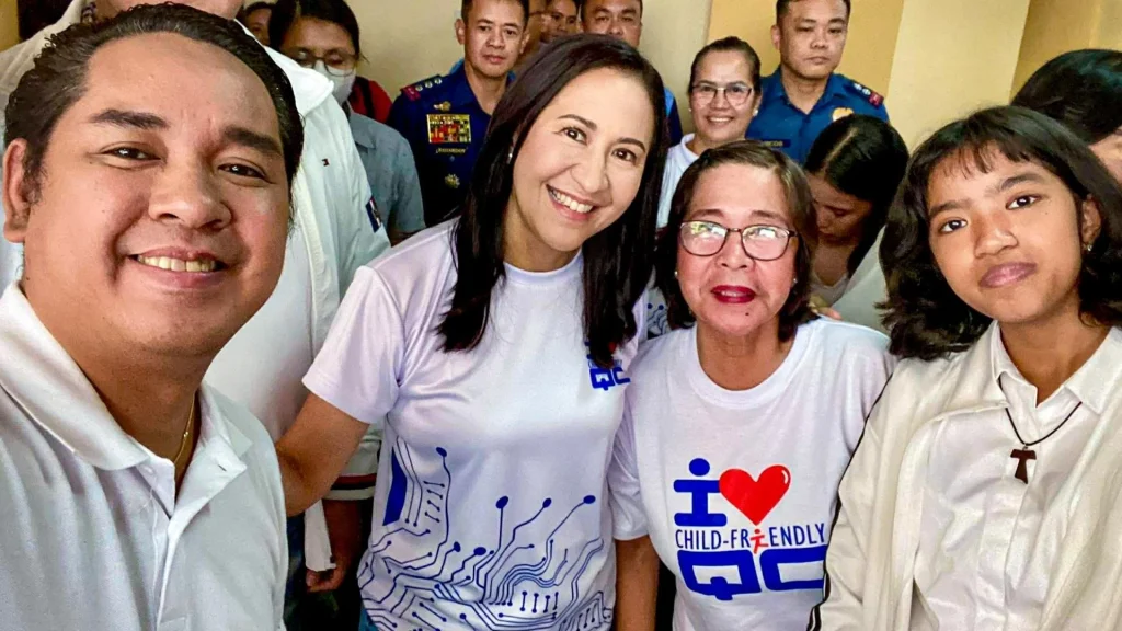 A diverse group of people smiling, wearing white shirts with various designs. The mood is joyful and friendly.