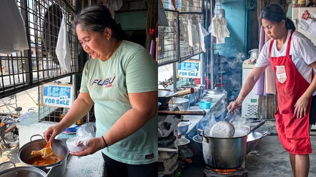 Two women are cooking in an outdoor kitchen. One stirs food in a pot, while the other ladles soup. Smoke rises, creating a busy, homely atmosphere.