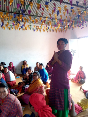 A Woman standing in front of other women