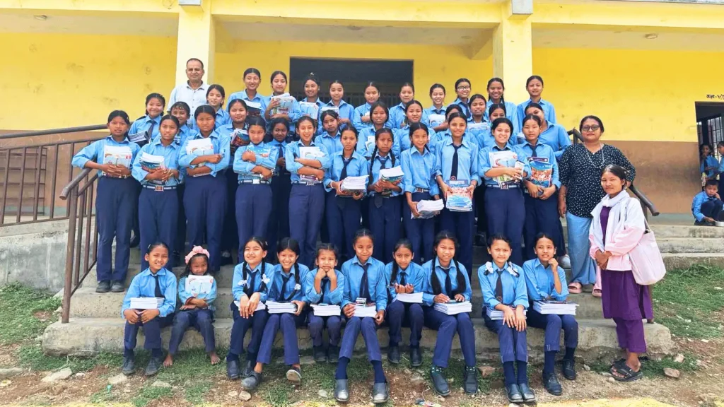 A cheerful group of school kids standing together, smiling for a group photo.