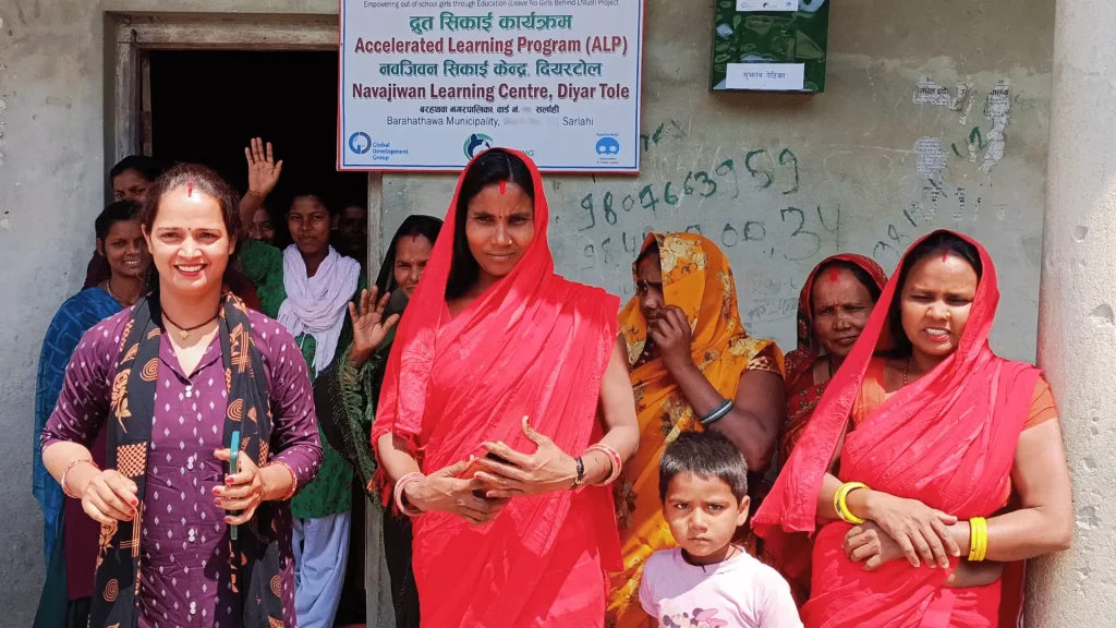A diverse group of women posing in front of a building.