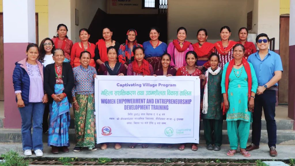 A group of women in vibrant red and blue dresses displaying a large banner.
