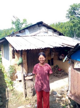 Girl Smiling in Front of a Shanty House
