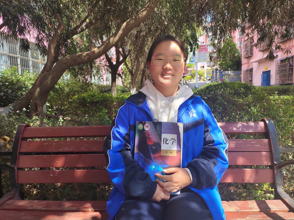 Student sitting on a bench in campus