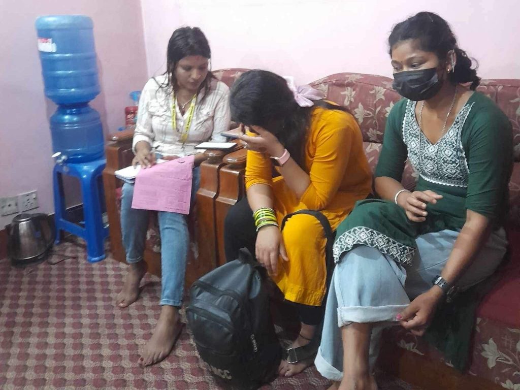 Two women talking to a staff member