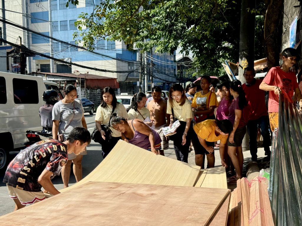 People carrying plywood