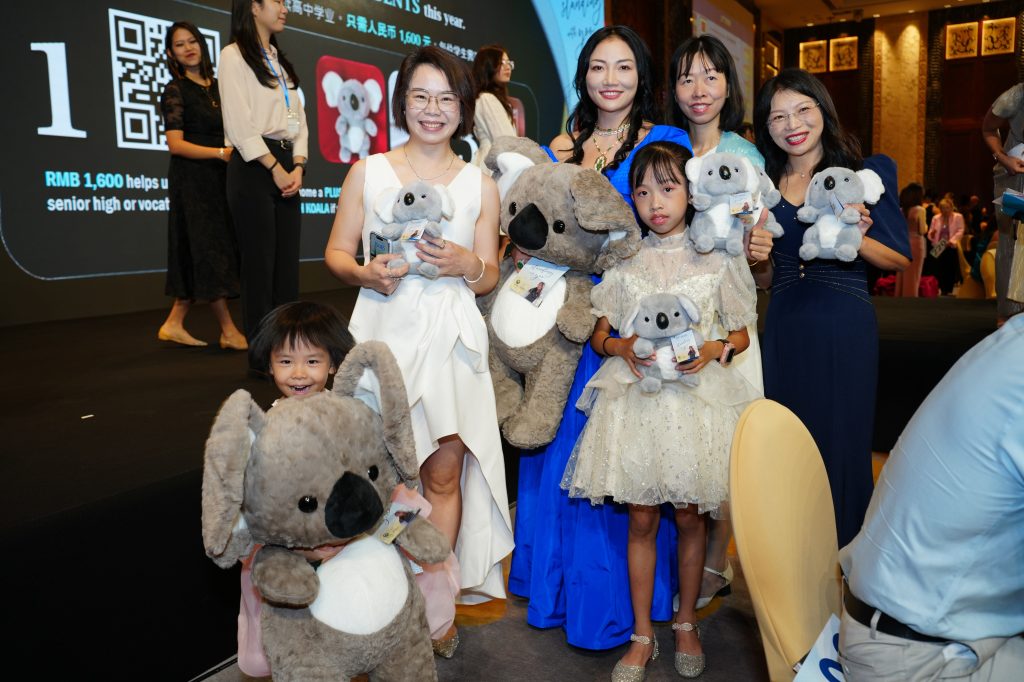 Attendees holding koala plushies