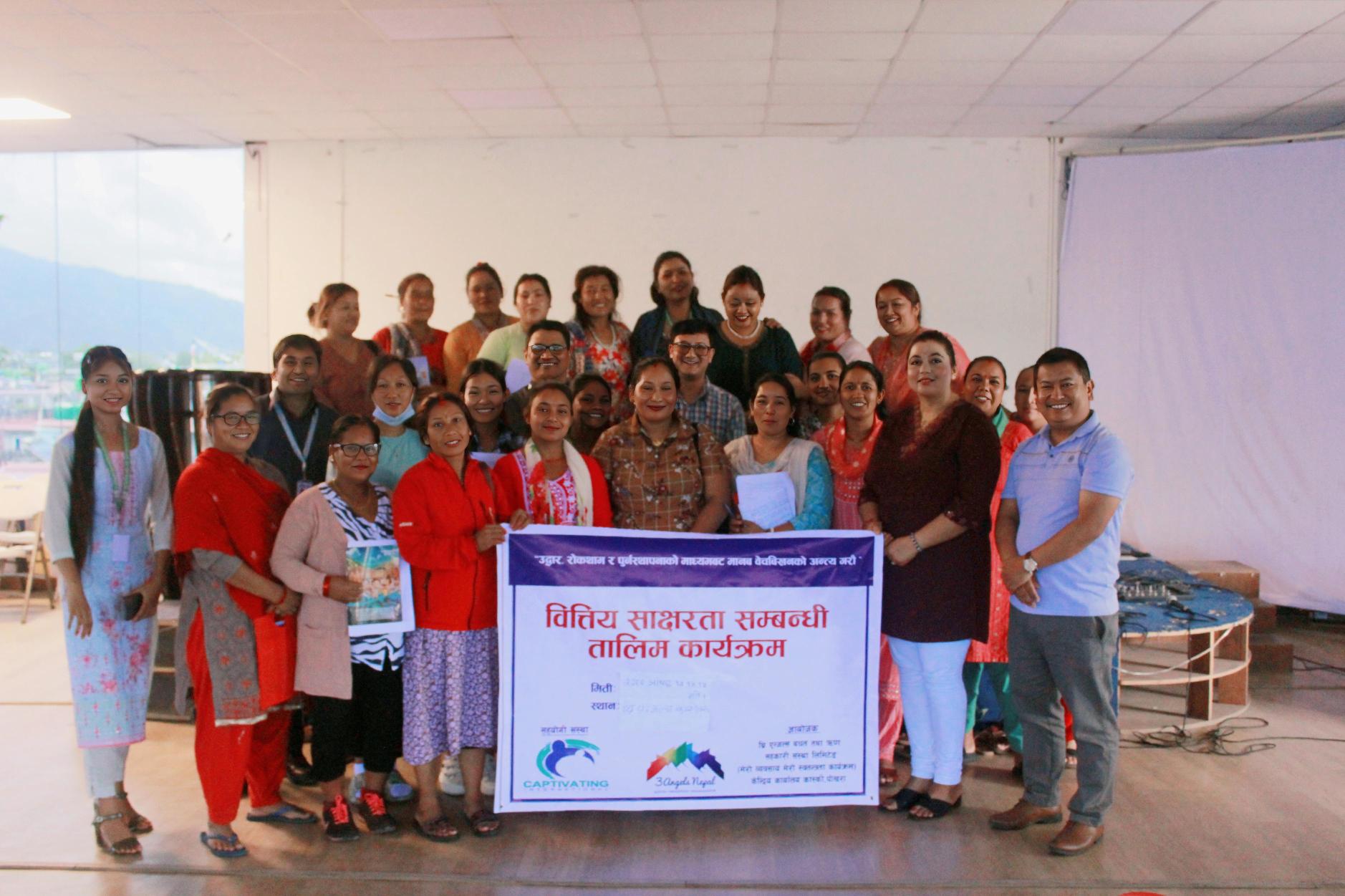 Nepali Women Holding Up Financial Literacy Program Poster
