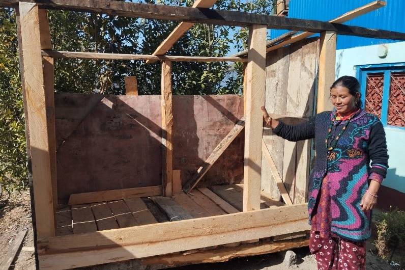 Woman holding a chicken coop