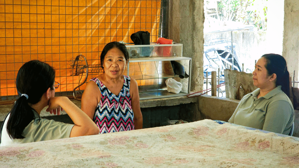 Three women looking happy and engaged in conversation.