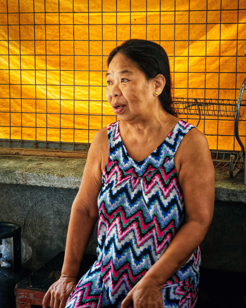 A woman casually seated on a bench.