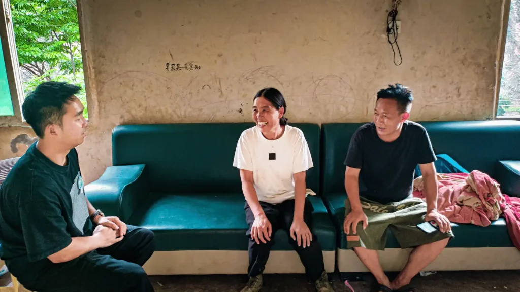 Three people sitting on a couch.