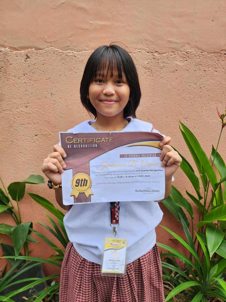 Young Girl Smiles with Her Certificate